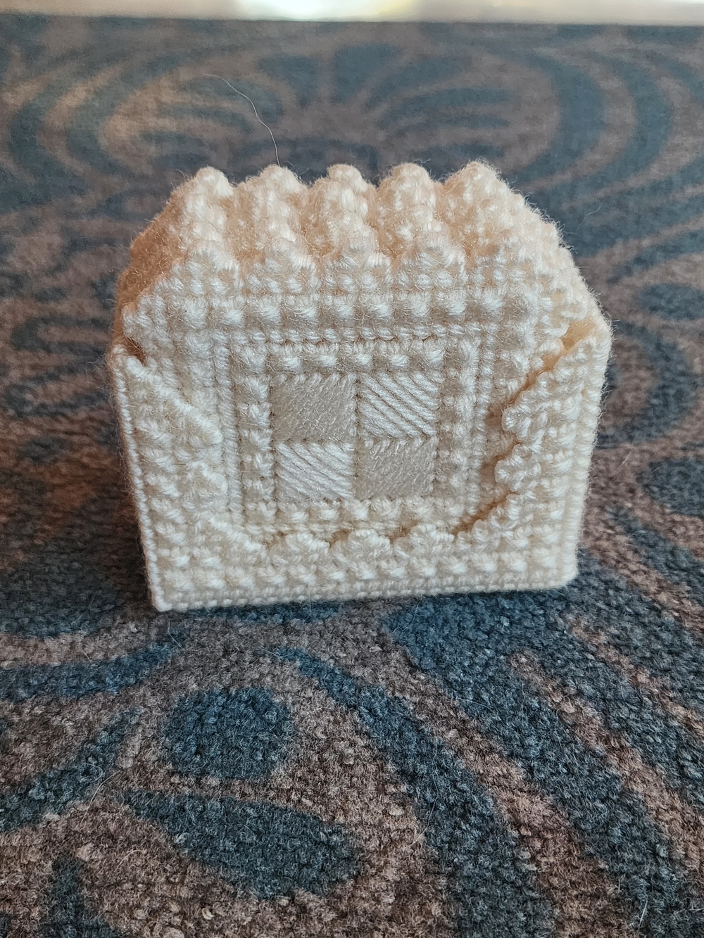 Handmade cream-colored plastic canvas coasters